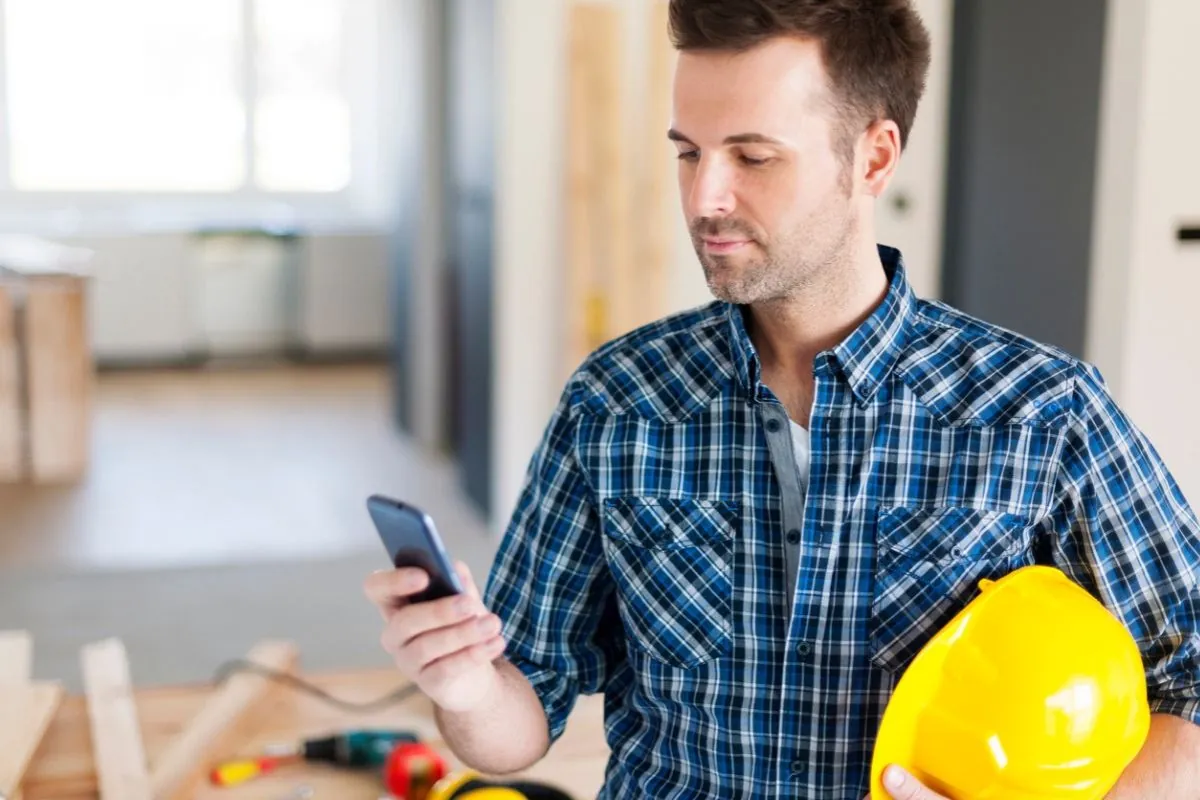 professional contractors holding phone