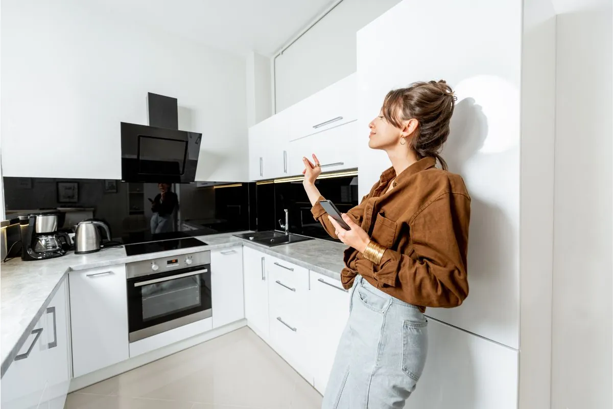 high end kitchen appliances with woman standing