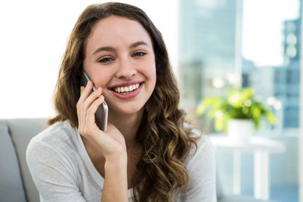 a happy woman calling on cellphone