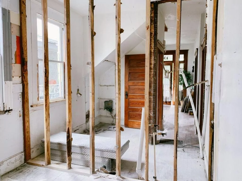 Home interior undergoing renovation with exposed framing